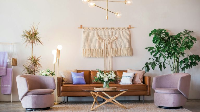 brown leather sofa and two pink sofa chair