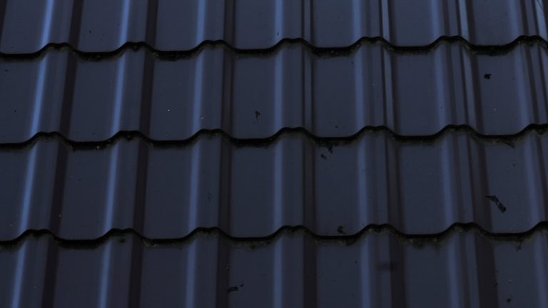 a close up of a metal roof with a sky background