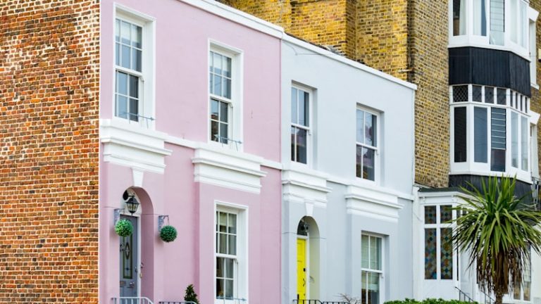 a row of pastel houses on a street corner