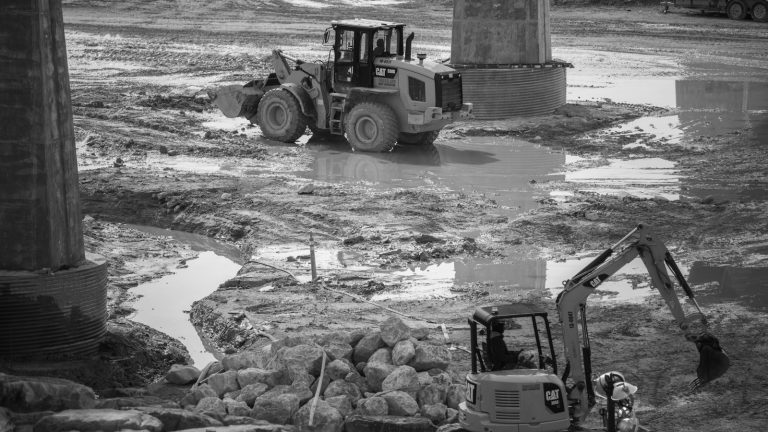 a construction site with a bulldozer in the middle of it