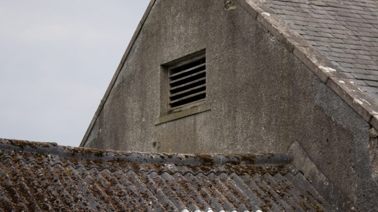 an old building with a small window on the roof