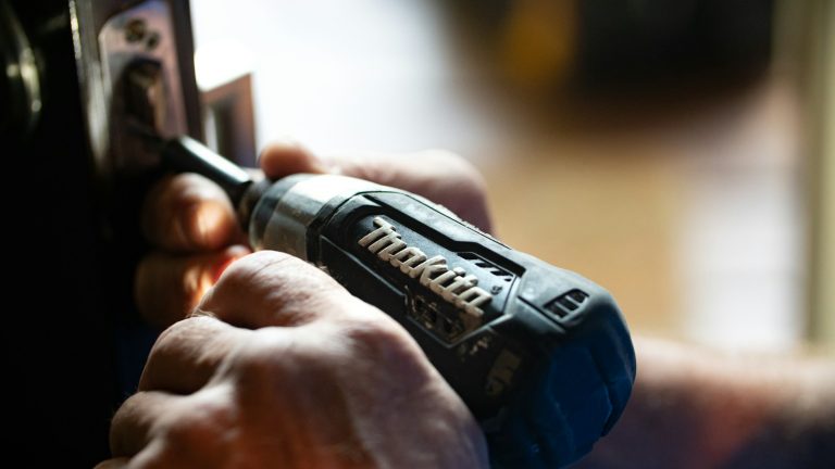 selective focus photography blue and black Makita power drill