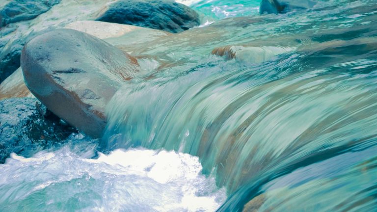 clear blue running water at daytime