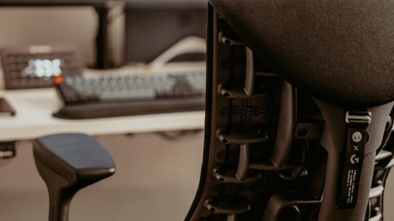 a black office chair sitting in front of a computer monitor